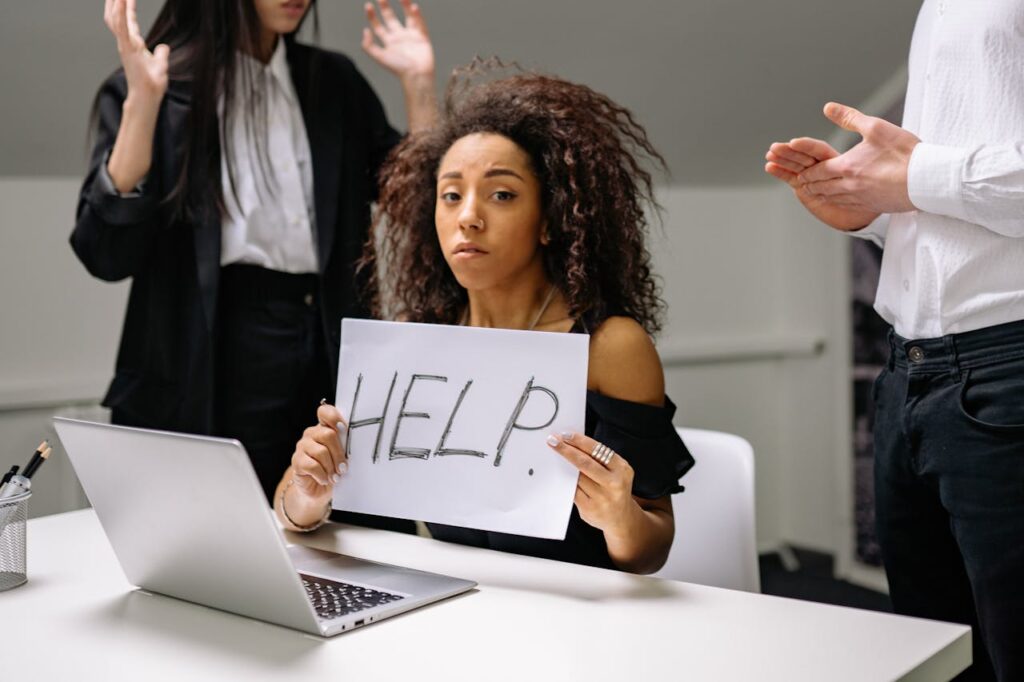 An unhappy businesswoman showing a sign reading 